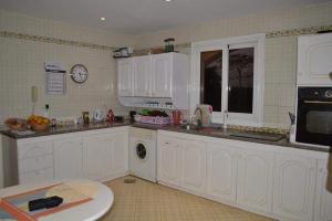 a kitchen with white cabinets and a washing machine at قصر 2 in Sharm El Sheikh