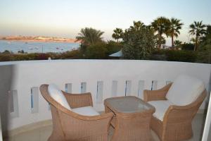 a couple of chairs and a table on a balcony at قصر 2 in Sharm El Sheikh