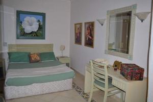 a bedroom with a bed and a desk and a table and a chair at قصر 2 in Sharm El Sheikh +7 photos