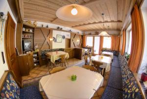 a restaurant with tables and chairs in a room at Roasnerhof in Finkenberg