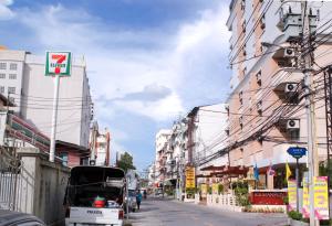 a city street with buildings and a truck on the street at K.V.Mansion in Bangkok