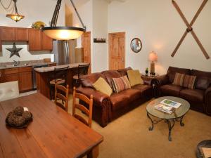 a living room with a couch and a table at Lionshead Arcade #303 Condo in Vail