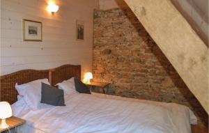 a bedroom with a bed and a brick wall at Awesome Home In Padirac With Wifi in Padirac