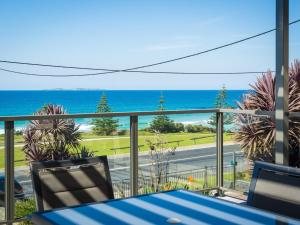 
a view from a balcony of a beach with a view of the ocean at 81 Dalmeny Drive - Beach House in Kianga
