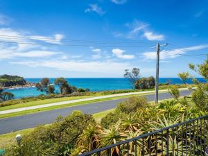
a view of a beach with a view of the ocean at 84 Ocean Parade in Dalmeny
