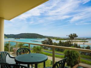 
a patio area with a view of the ocean at Grand Pacific 2 Unit 1 in Narooma
