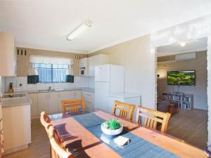 a kitchen and dining room with a table and chairs at Apollo Unit 12 Ground Floor in Narooma