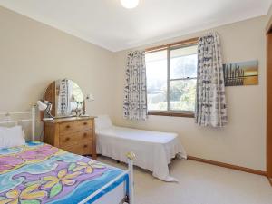 a bedroom with two beds and a window at 120 Ocean Parade Dalmeny in Dalmeny