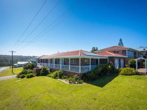 a house with a large lawn in front of it at 120 Ocean Parade Dalmeny in Dalmeny