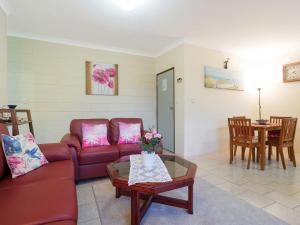 a living room with a couch and a table at Apollo Unit 8 1st Floor in Narooma