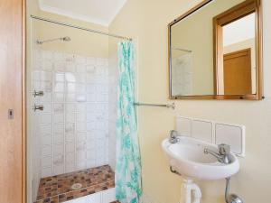 a bathroom with a sink and a shower at Grandview Apartment Ocean Views in Kianga