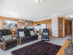 
a living room filled with furniture and a tv at Grand Pacific 2 Unit 2 in Narooma
