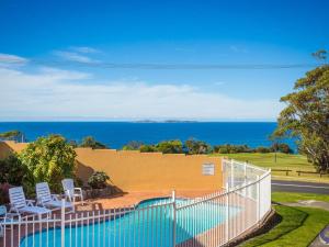 
a beach scene with a view of the ocean at Countess Court Unit - Great Ocean Views in Narooma
