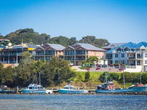 
a large body of water with houses and boats at Grand Pacific 1 Unit 1 in Narooma
