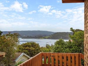 
a wooden deck overlooking a city with a view of the water at Forsters Bay Haven in Narooma
