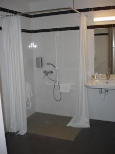 a bathroom with a shower and a sink at Hotel-Restaurant Du Lac in Joue-les-Tours