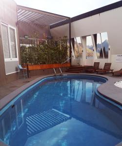 a large swimming pool with chairs and a patio at Rydges Lakeland Resort Queenstown in Queenstown