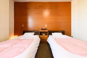 Voodi või voodid majutusasutuse Tabist HotelNakajima Fuji toas