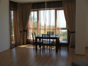 a dining room with a table and chairs in front of a window at Cabacum Beach Private Apartaments in Golden Sands