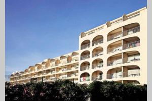 a large white building with balconies on it at Escapade au port in Hyères