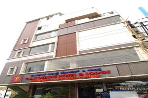 a large building with a sign in front of it at PPH Living BSK Deluxe in Bangalore