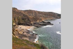 an aerial view of a beach with the ocean at A Casa da Foz Moradia com vista mar in Sesimbra +20 photos