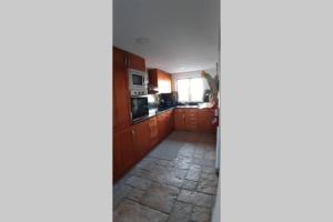 a view of a kitchen from the hallway at A Casa da Foz Moradia com vista mar in Sesimbra