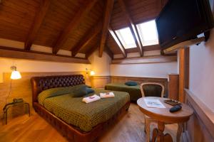 מיטה או מיטות בחדר ב-Albergo Villino Quintiliani