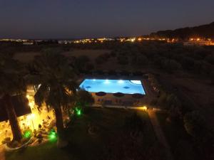 a view of a swimming pool at night at HOTEL TINA FLORA in Kolymbia