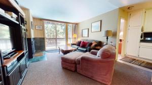 a living room with a couch and a television at Crestview #25 condo in Mammoth Lakes