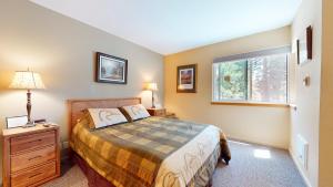 a bedroom with a bed and a window at Crestview #25 condo in Mammoth Lakes +23 photos