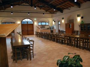 a large room with wooden tables and chairs at Il Vecchio Mulino in Volterra
