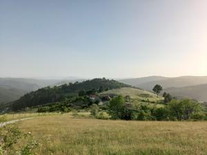 a view of a field with mountains in the background at Laki Marjanovic in Zlatibor