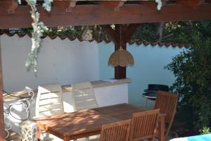 a wooden table and chairs on a patio at Villa Verde Apartments and Rooms in Premantura