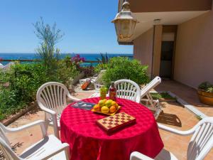 a table with a red table cloth and a plate of fruit at Appartement Menton, 2 pièces, 4 personnes - FR-1-196-178 in Menton