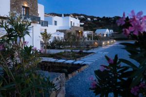 a view of a building at night with flowers at Archon Seaside Retreat in Plaka