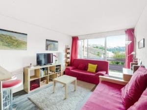 a living room with a red couch and a window at Studio Villard-de-Lans, 1 pièce, 4 personnes - FR-1-515-96 in Villard-de-Lans