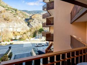 a balcony with a view of a street and mountains at Studio Brides-les-Bains, 1 pièce, 4 personnes - FR-1-512-227 in Brides-les-Bains