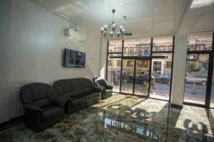 a living room with a couch and a chandelier at HOTEL LORD in Batumi