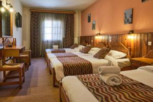 Postel nebo postele na pokoji v ubytování Hotel Victoria