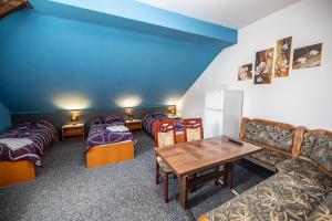 a room with beds and a table and a couch at Penzion Grasel in Nové Syrovice +54 photos