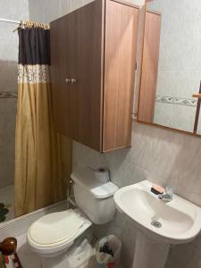 a bathroom with a toilet and a sink at Acogedor y cómoda casa vacacional Condominios Flandes in Flandes