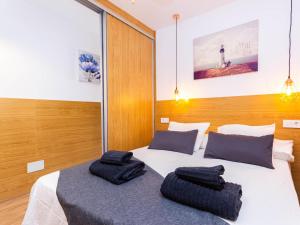 a bedroom with a bed with two towels on it at Lighthouse Friendly Holiday Home in Playa del Ingles +24 photos
