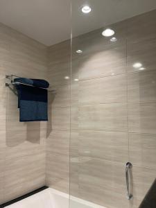a shower with a glass door in a bathroom at One Bedroom Apartment DAMAC Celestia -EXPO Road in Dubai