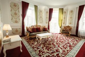 a living room with a couch and a table at Royal Grand Hotel in Kyiv