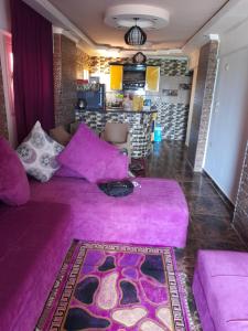 a living room with a pink couch in a room at Family Condo With Panoramic Sea View 1 in Alexandria