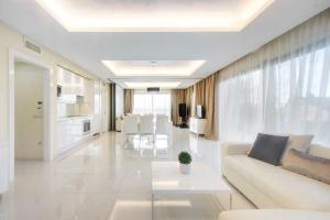 a white living room with a couch and a table at White Luxury Villa Esztergom in Esztergom