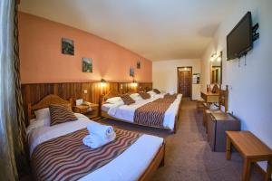 Postel nebo postele na pokoji v ubytování Hotel Victoria