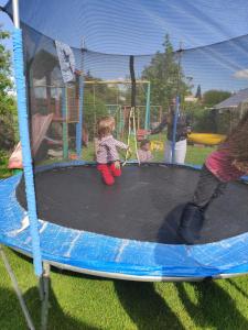 a small child sitting on a trampoline at VILLA GUT in Bolesławiec
