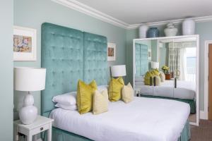 a bedroom with two beds with yellow pillows at Roslin Beach Hotel in Southend-on-Sea
